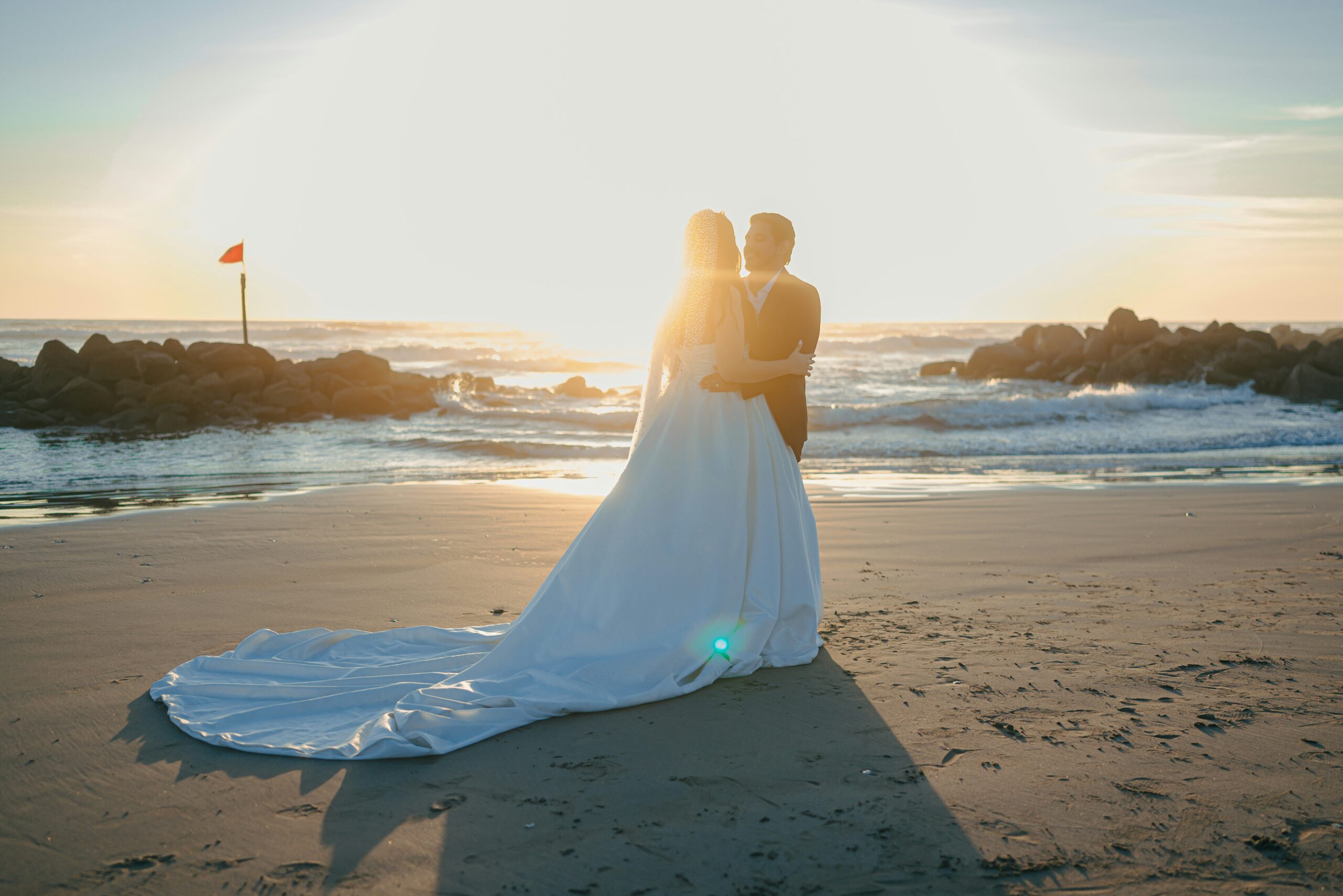 Bride and groom embracing at golden hour on their wedding day